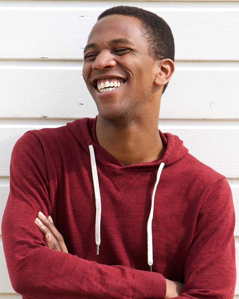 standing young man smiles